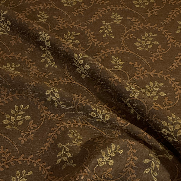 Close-up of brown fabric with intricate floral pattern