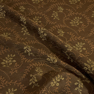Close-up of brown fabric with intricate floral pattern