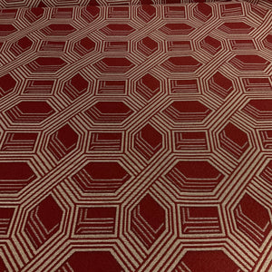 Hexagonal patterned fabric with a geometric design on a red background