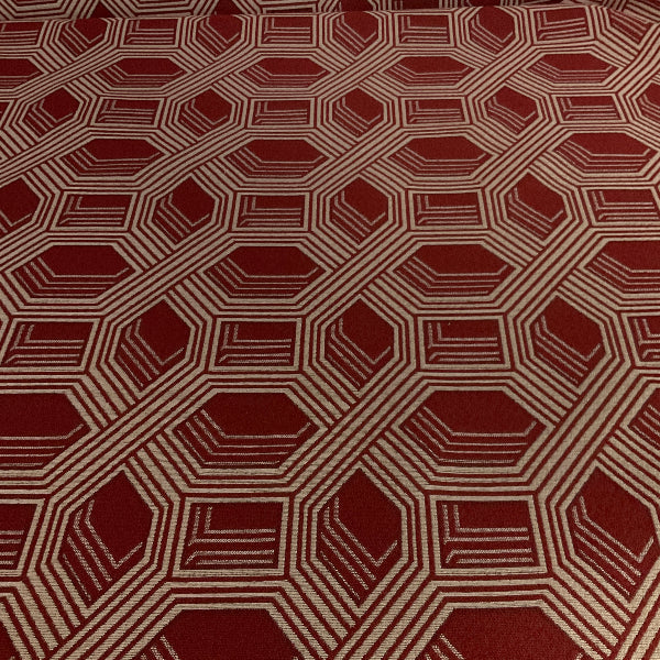 Hexagonal patterned fabric with a geometric design on a red background